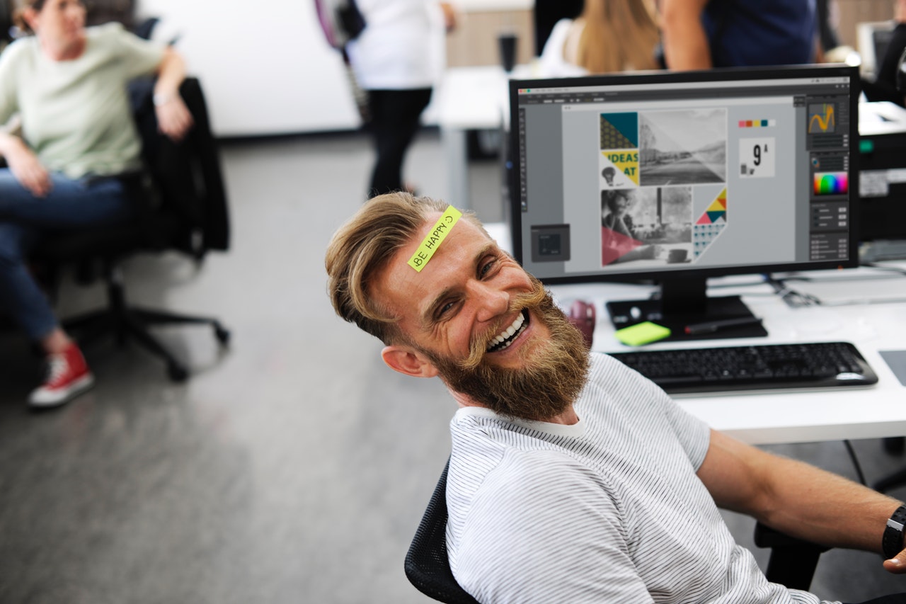 Man Laughing Beside Computer Monitor