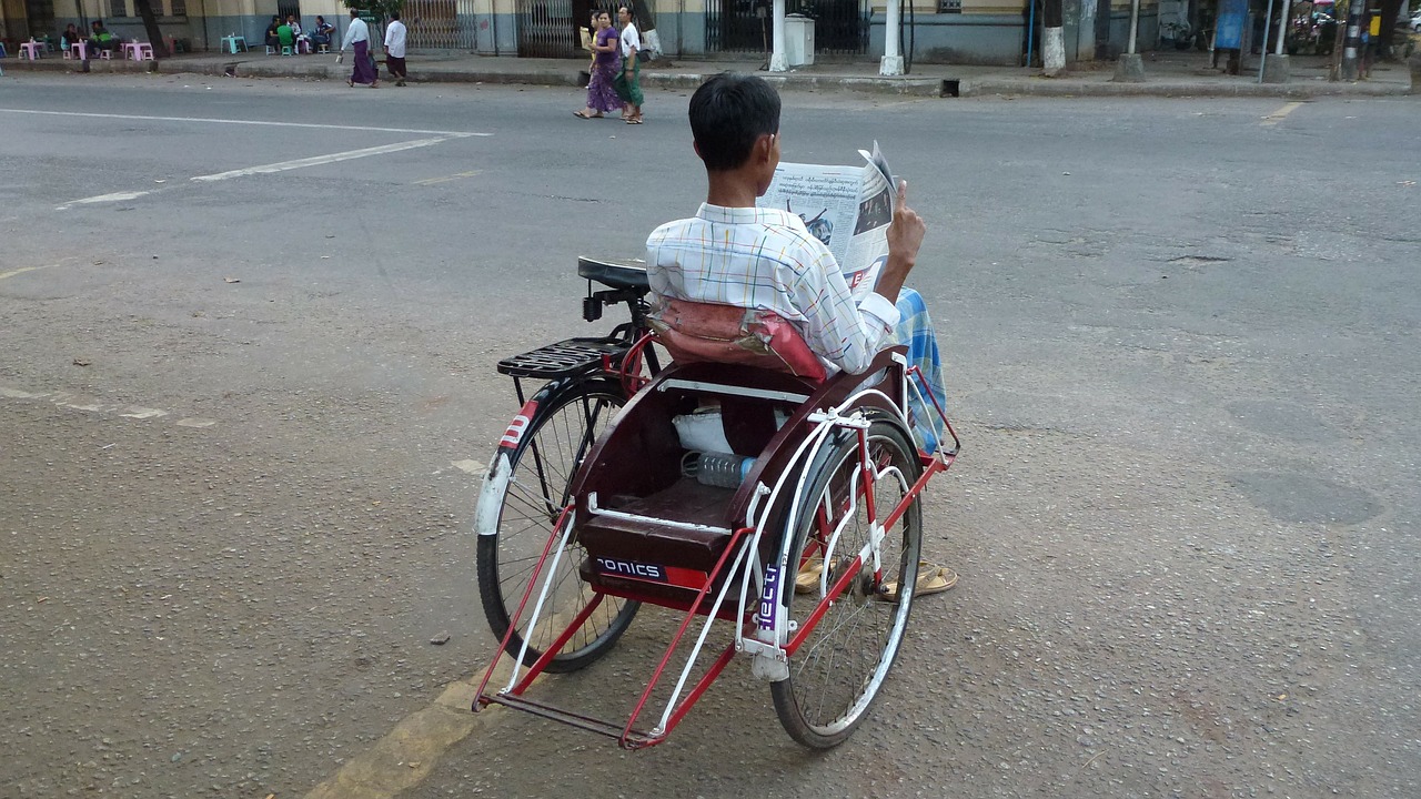 Man in Wheelchair Reading Newspaper
